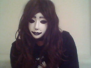 Crossdresser shows off mask on webcam